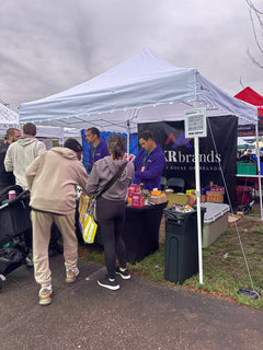 Happy Duck booth at Legacy Cup 2026 with customers at the table